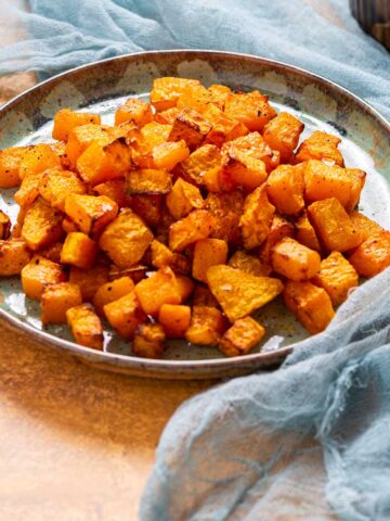 a side view of a plate of roasted butternut squash