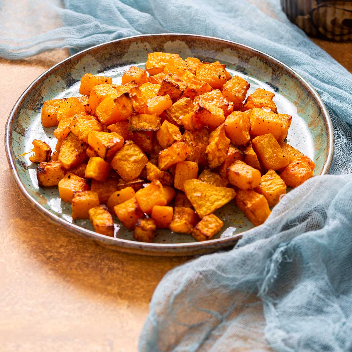a side view of a plate of roasted butternut squash