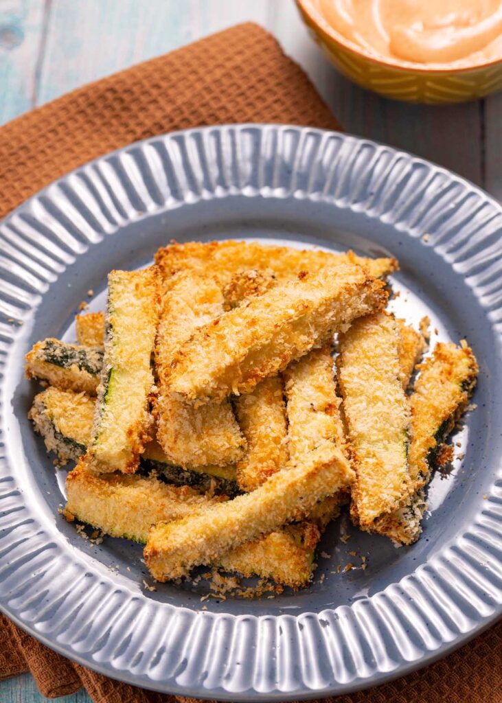 air fried zucchini fries on a gray plate.