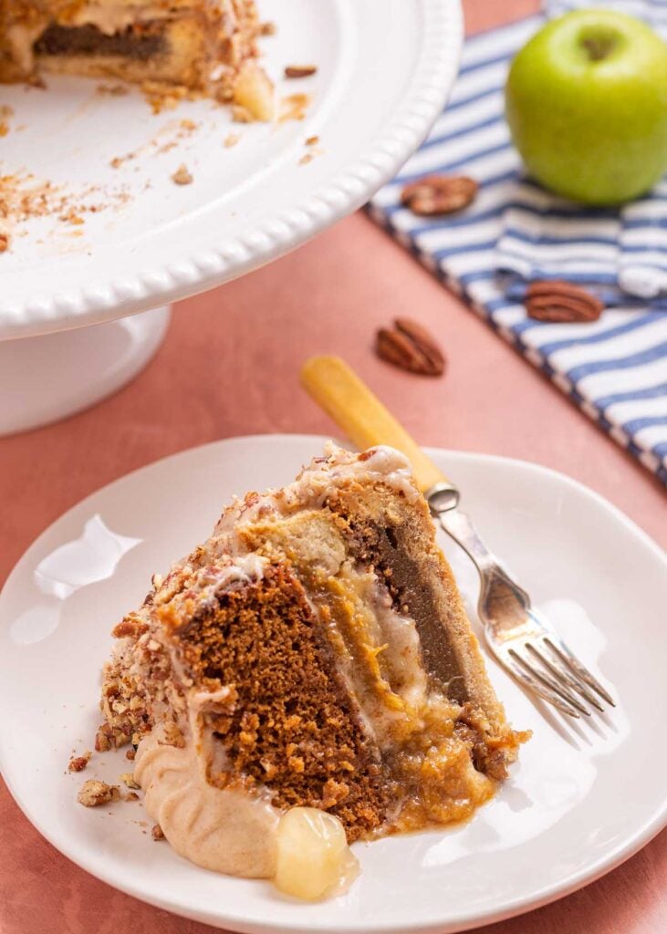 a slice of Piecaken next to a pie pedistal.